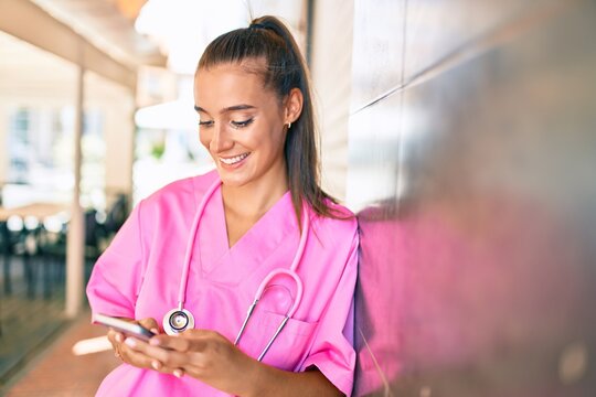 Young hispanic doctor woman speaking on the smartphone at street of city.