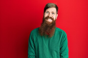 Redhead man with long beard wearing casual clothes with a happy and cool smile on face. lucky person.