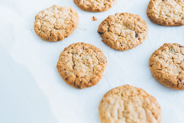 Oatmeal homemade cookies on white table. Space for text. Healhy desserts.