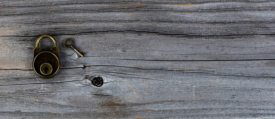 Antique lock with key on vintage wooden planks
