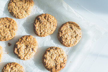 Oatmeal broun homemade cookies on white table. Healhy desserts, diet