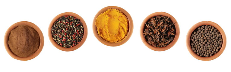 Set spice, cinnamon, colorful mixed pepper grains, turmeric powder (curcuma), star anise, allspice, pimento spice, Jamaican pepper in clay pot isolated on white background, top view and clipping path