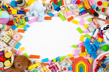 Fototapeta na wymiar Baby kids toys frame. Set of colorful educational wooden and fluffy toys on white background. Top view, flat lay, copy space for text