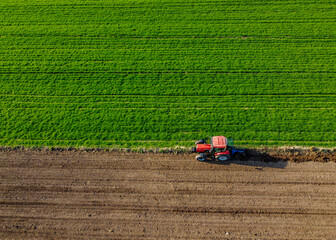 Fototapeta na wymiar Tractor Ploughing Field Centre Horizontal