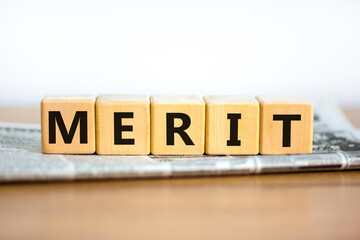 Merit symbol. Wooden cubes with the word 'merit'. Beautiful white background, copy space....