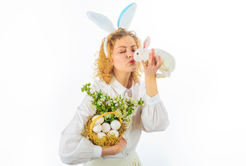 Beautiful young woman kissing white rabbit. Cute girl on Easter day. Hunts for Easter eggs.