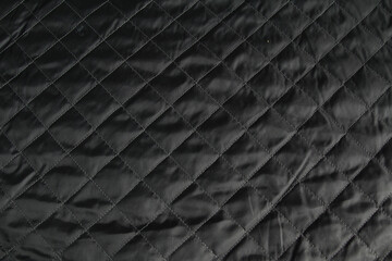 Factory quilted fabric in black. Abstract background
