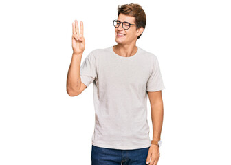 Handsome caucasian man wearing casual clothes and glasses showing and pointing up with fingers number three while smiling confident and happy.