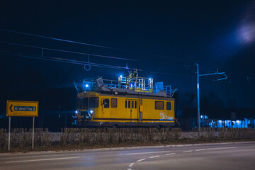 Work train for catenary maintenance at night. Workers working at night to allow the railway line to be opened in the morning.