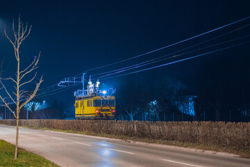 Work train for catenary maintenance at night. Workers working at night to allow the railway line to be opened in the morning.