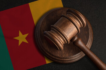 Judge gavel and flag of Cameroon. Law and justice in Cameroon. Violation of rights and freedoms