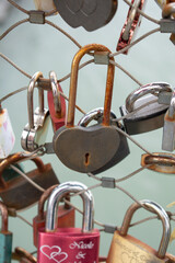 Fototapeta na wymiar Love padlocks with heart shape. Concept of love. Metallic love padlock on a bridge full of padlocks.