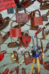 Love padlocks with heart shape.  Concept of love. Metallic  love padlock on a bridge full of padlocks.