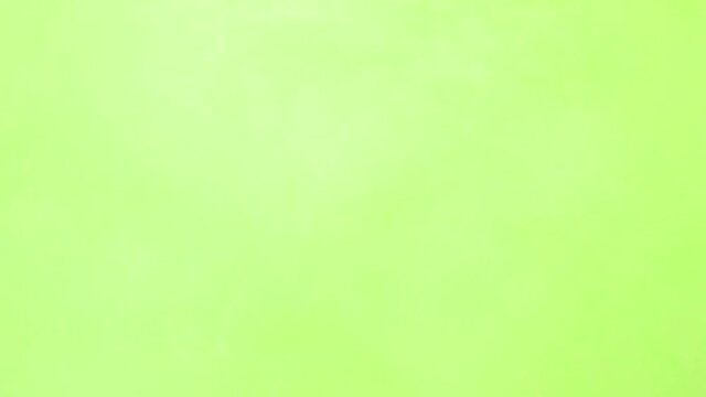 Green ink spreading in water on white. Abstract color background, liquid smoke, psychedelic and art concept. Green screen smoke effect.