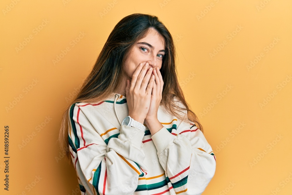 Canvas Prints Young caucasian woman wearing casual clothes laughing and embarrassed giggle covering mouth with hands, gossip and scandal concept