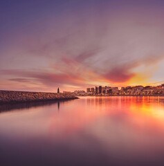Beacon lighthouse and city skyline at sunset in Aguadulce, Roquetas de Mar, Almeria, Spain. Travel in holidays © Eusebio Torres