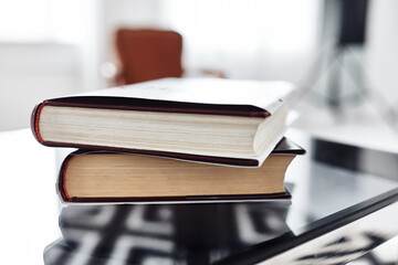 A collection of luxury books white and black colors, sitting on a table. Fashion background. Book with blank cover.