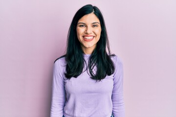 Fototapeta premium Young hispanic woman wearing casual clothes with a happy and cool smile on face. lucky person.