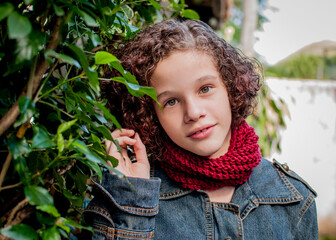 Portrait of curly short hair girl wearing red knitting collar 