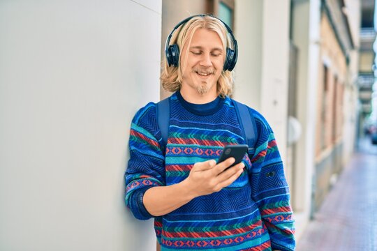 Young Scandinavian Student Man Smiling Happy Using Smartphone And Headphones At The City.