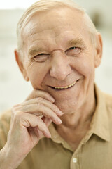 Happy aged gentleman smiling and posing for camera