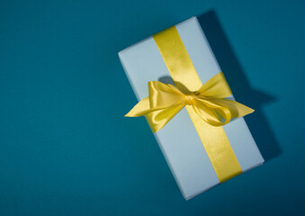 Gift boxes with different colors on a banner template. Blue gift box and yellow bow against blue background.