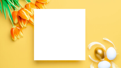 Easter frame. Golden, white colour egg in basket with spring tulips, feathers on pastel yellow background in Happy Easter decoration. Festive design in flat lay.