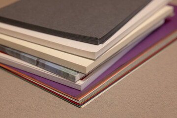 stack of books and sheets  on gray background 
