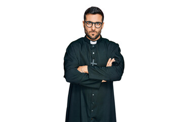 Young hispanic man wearing priest uniform skeptic and nervous, disapproving expression on face with...