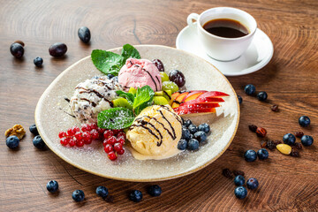 three balls of colorful ice cream on a large plate 