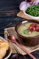 Popular dish of Portuguese cuisine called Caldo Verde. Made with potatoes, bacon, pepperoni sausage and kale. Copy space