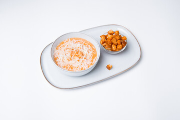 Plate of soup creme with chicken and cheese with crackers