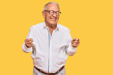 Senior caucasian man wearing business shirt and glasses excited for success with arms raised and eyes closed celebrating victory smiling. winner concept.