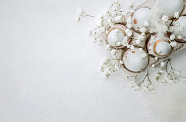easter banner, easter painted eggs, flowers  and feathers on light background