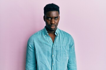 Fototapeta premium Handsome black man wearing casual clothes depressed and worry for distress, crying angry and afraid. sad expression.