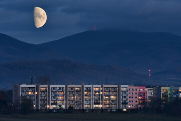 Bystrzyca Klodzka, moonrise over the city against the backdrop of mountains. © Castigatio