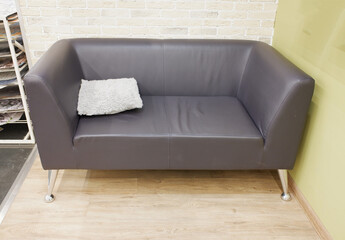 gray sofa with a pillow showcase in the store. house reconstruction and renovation