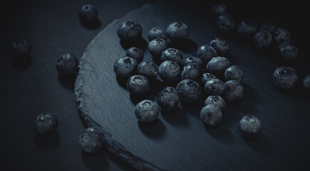 Juicy blueberries on a dark background
