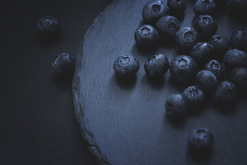 Juicy blueberries on a dark background