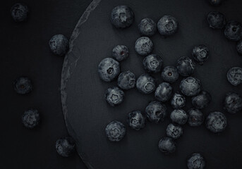 Juicy blueberries on a dark background