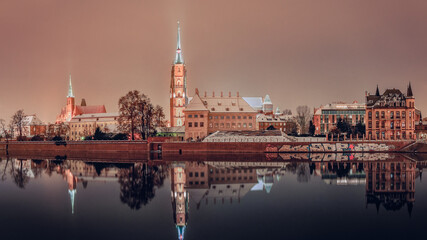 Cathedral of St. John the Baptist, Collegiate Church of the Holy Cross and Saint Bartholomew in Wroclaw on the Odra River, illuminated at night.