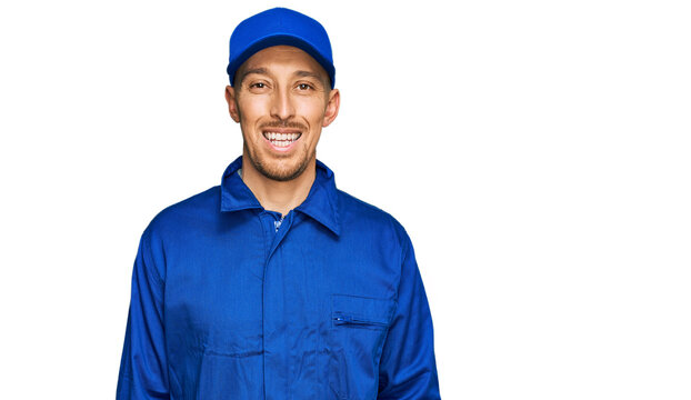 Bald man with beard wearing builder jumpsuit uniform with a happy and cool smile on face. lucky person.