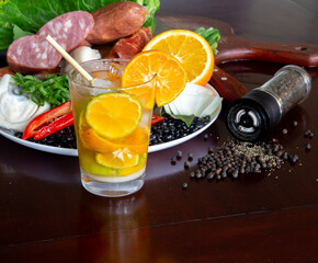 Typically Brazilian feijoada, ingredients, pepperoni sausage, paio, pepper, pork, black beans, bay leaf, cracklings and caipirinha with lemon and cachaça