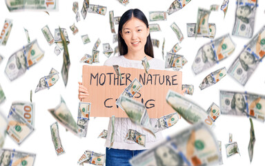 Young beautiful chinese woman holding mother nature is crying cardboard banner looking positive and happy standing and smiling with a confident smile showing teeth