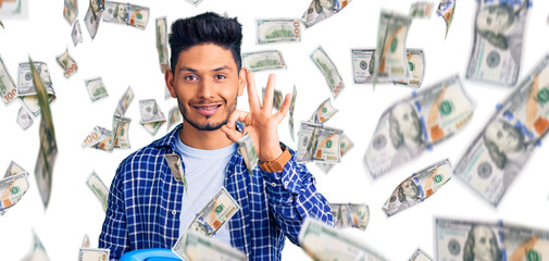 Obraz premium Handsome latin american young man holding vintage telephone doing ok sign with fingers, smiling friendly gesturing excellent symbol