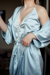 a young, beautiful woman in a blue nightgown. selective focus with a small focus area. crop without a face on the details