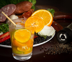 Typically Brazilian feijoada, ingredients, pepperoni sausage, paio, pepper, pork, black beans, bay leaf, cracklings and caipirinha with lemon and cachaça