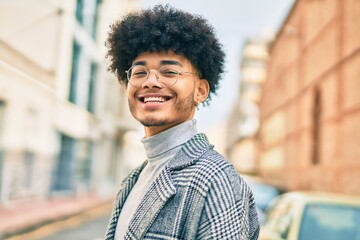 Young african american businessman smiling happy standing at the city.