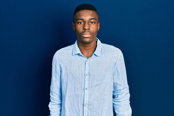 Obraz premium Young african american man wearing casual clothes relaxed with serious expression on face. simple and natural looking at the camera.