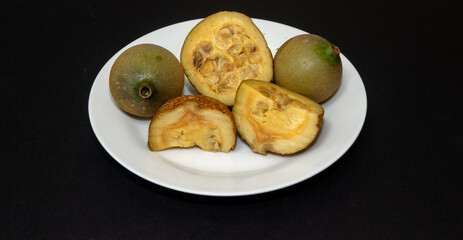 Jenipapo, American Genipa, ripe fruits cut in half showing their interior. Typically Brazilian fruit very rich in iron and used to make liqueur